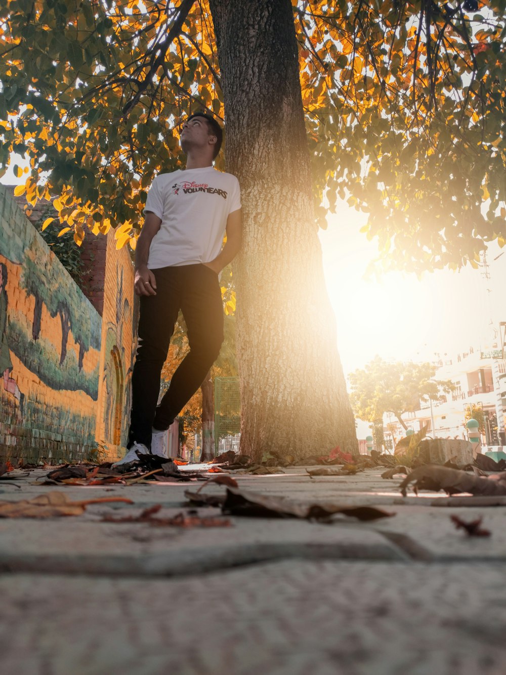 man standing under tree