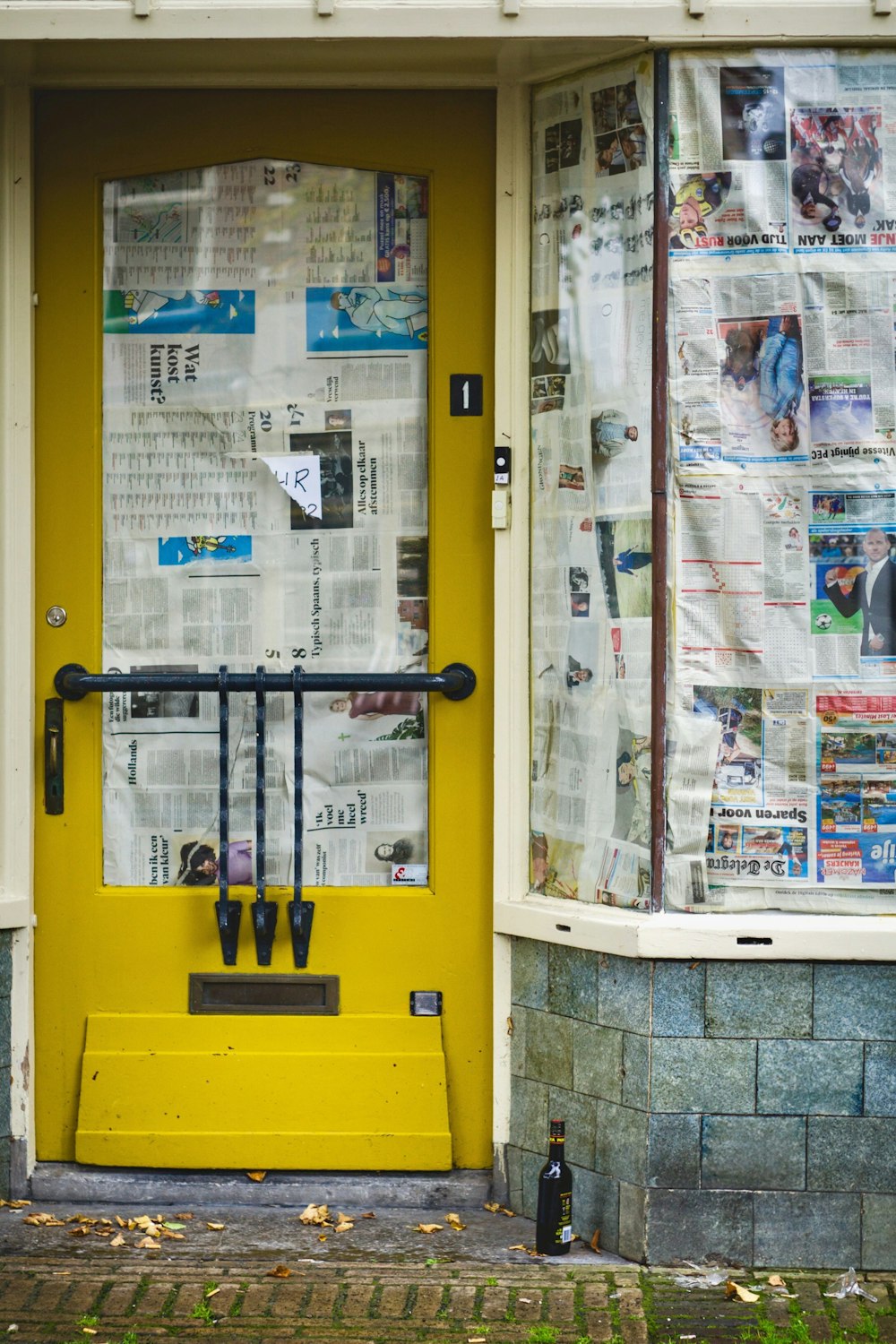 a yellow door with newspaper on it