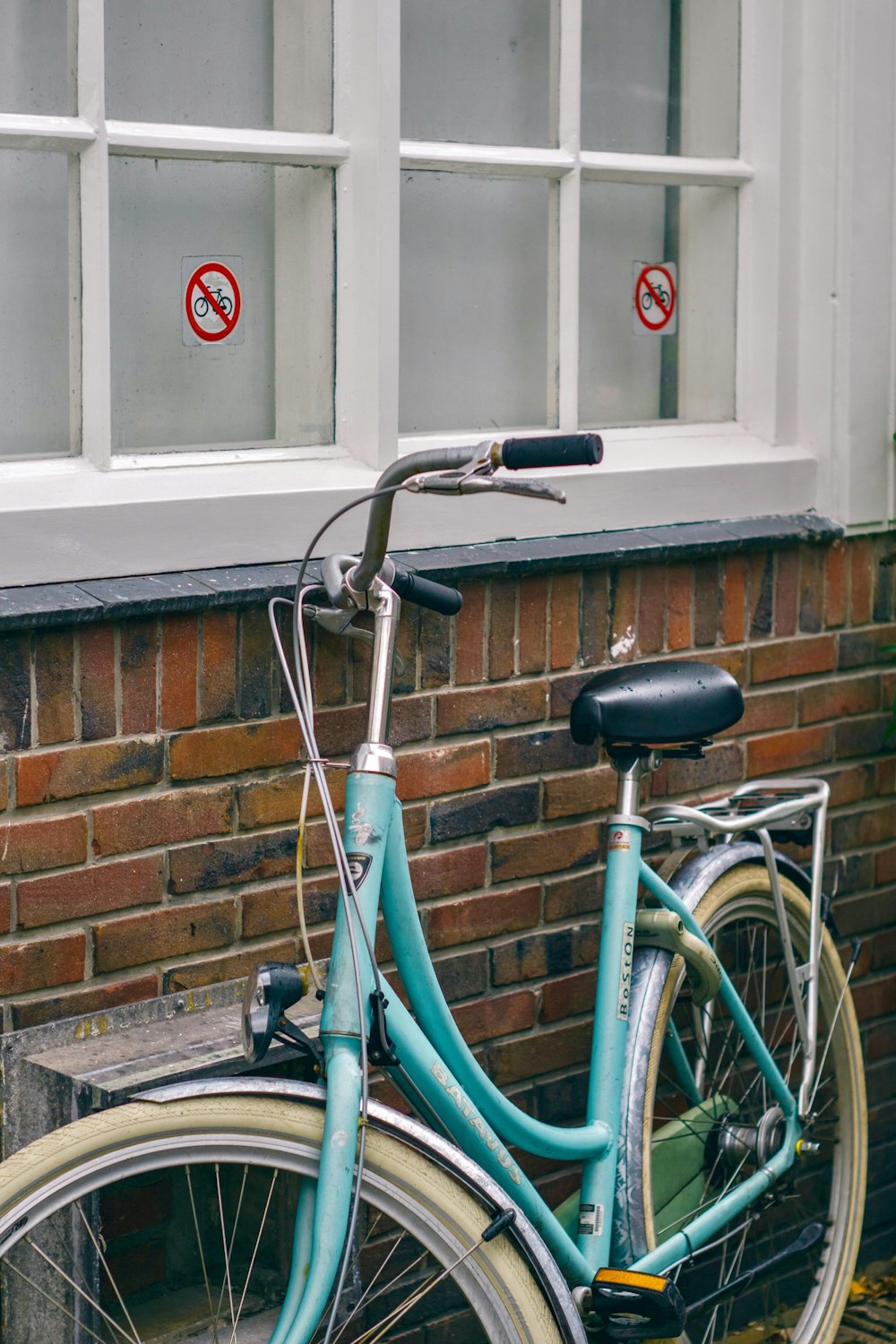 parked blue and yellow bicycle