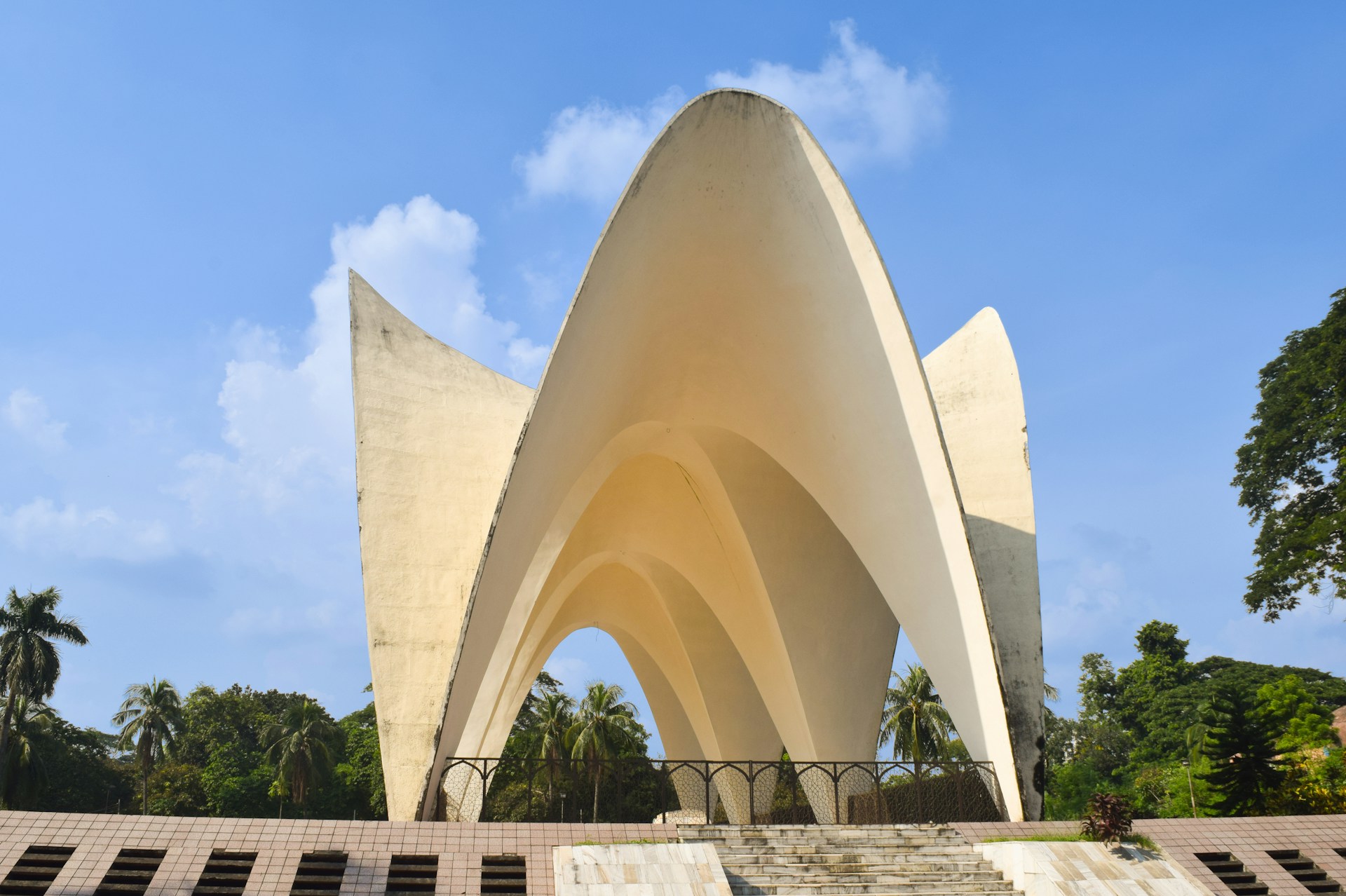 woman wearing yellow long-sleeved dress under white clouds and blue sky during daytime