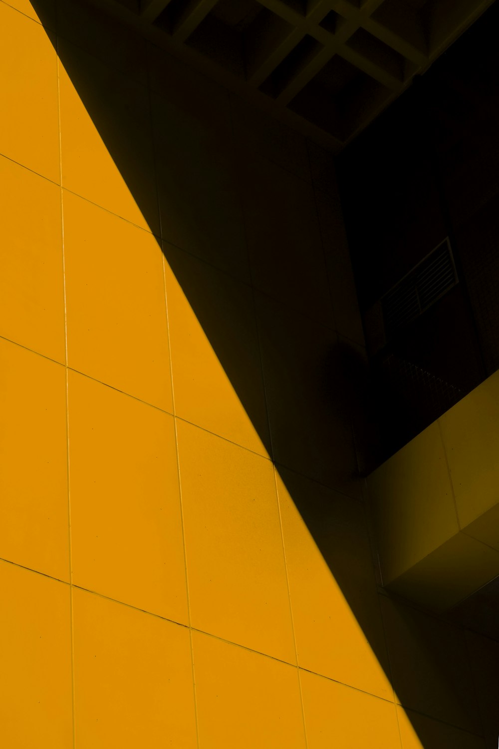 a close up of a clock on a yellow wall