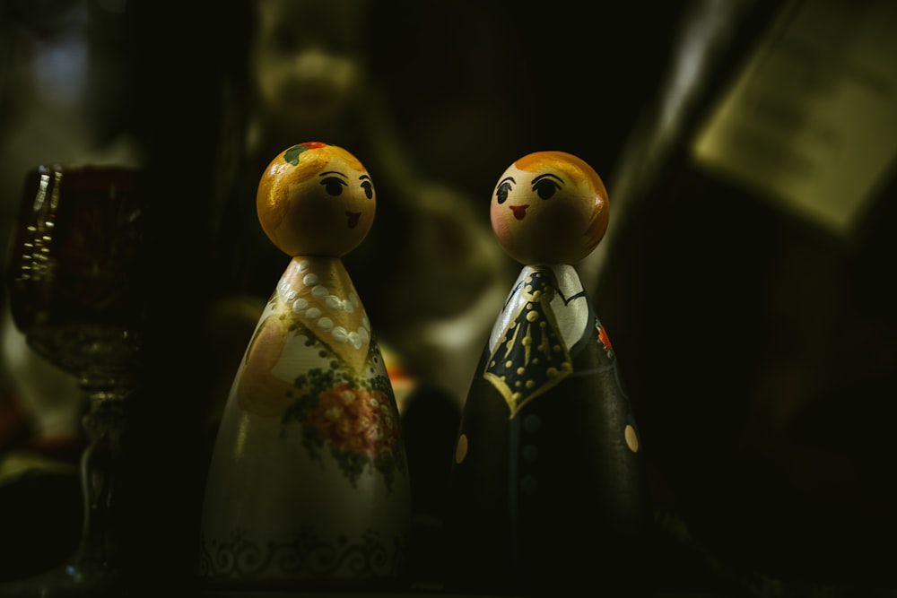 two Russian dolls on dark surface