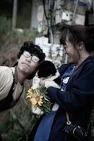 A happy family holding their newly adopted pet outside their home, smiles all around.