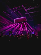 people performing on stage near partying people