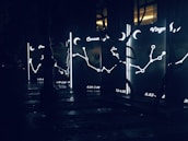 An artistic depiction of zodiac symbols softly illuminated by starlight.