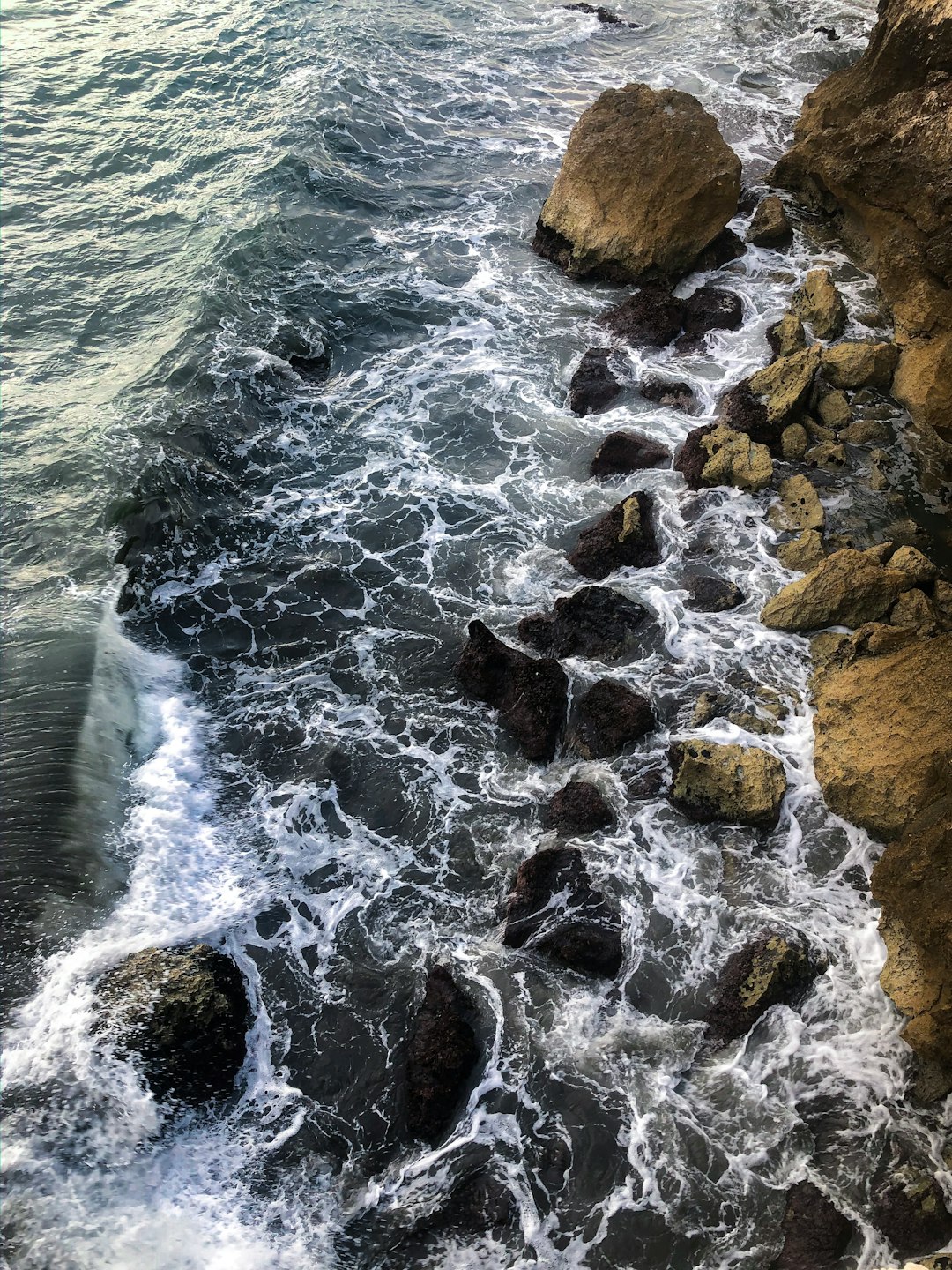 brown rock formations near body of water