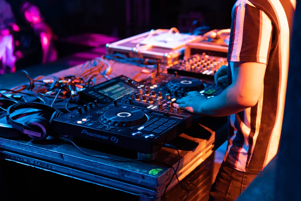 person standing while using DJ mixer