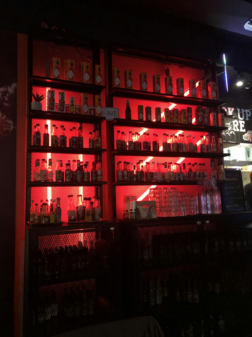 pile of liquor bottles in cabinet