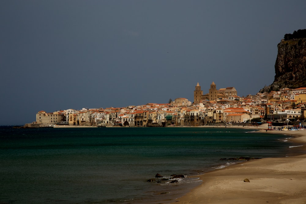 concrete buildings beside sea at daytime