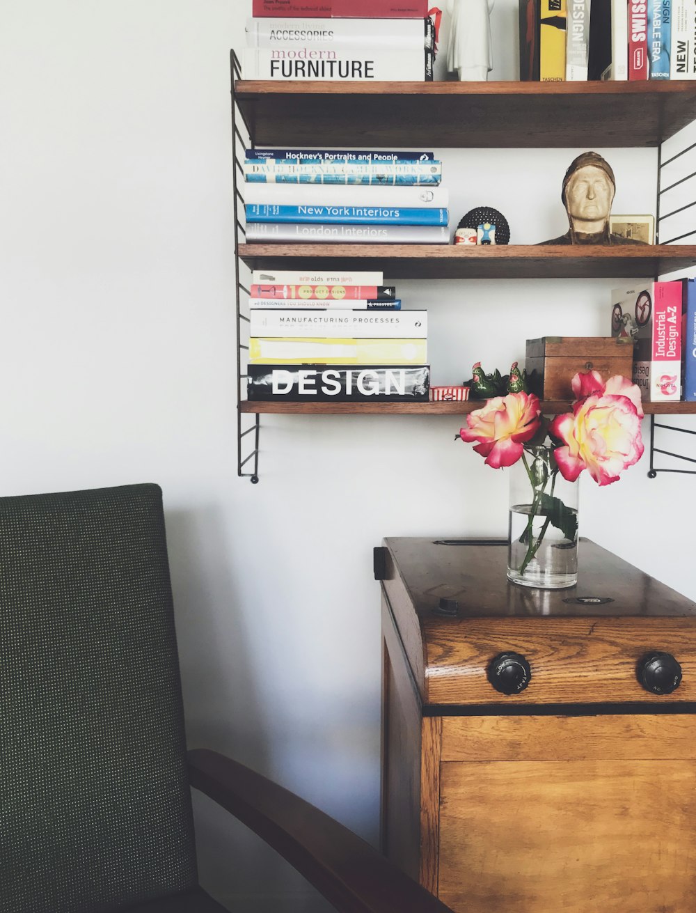 a wooden desk with a vase of flowers on top of it