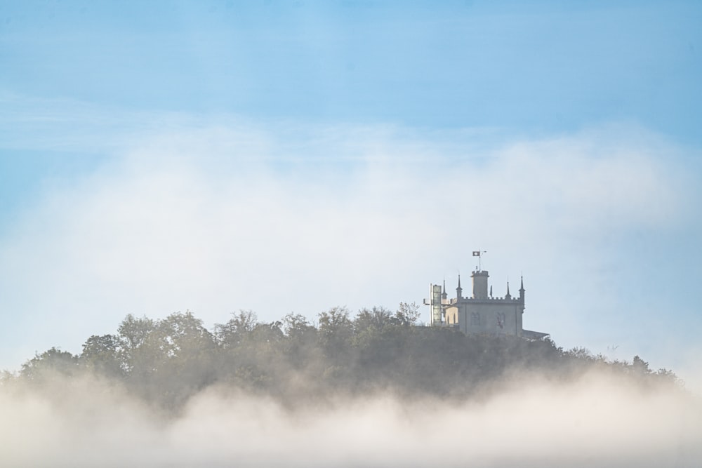 castle on top of hill under blue skies