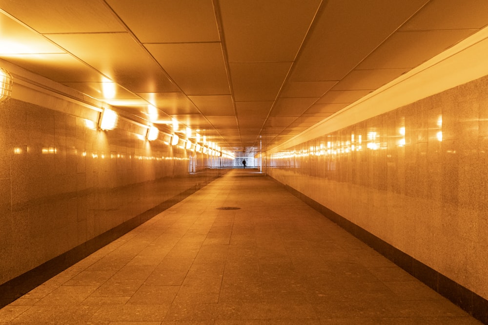 turned-on lights of an empty hallway