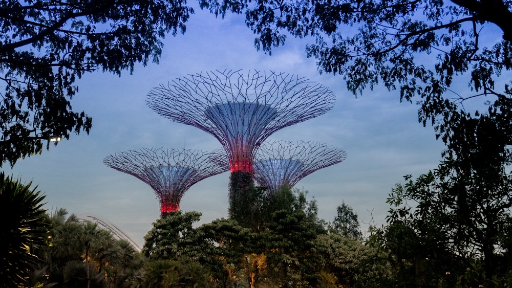 three structures near trees during day