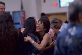 selective focus photography of two women hugging