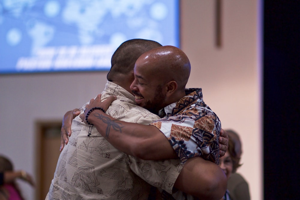 two man hugging on focus photography