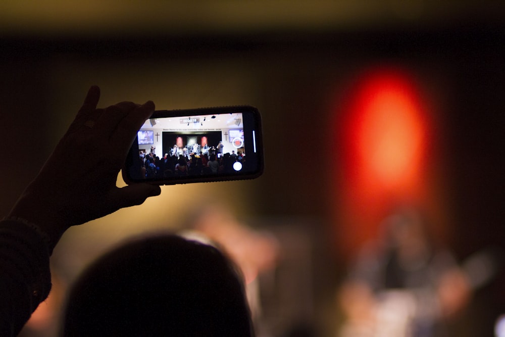 selective focus photography of person holding smartphone