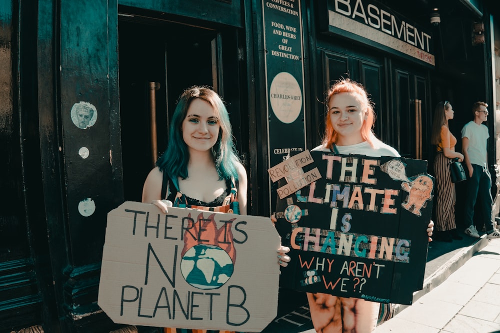 two women holding board signs