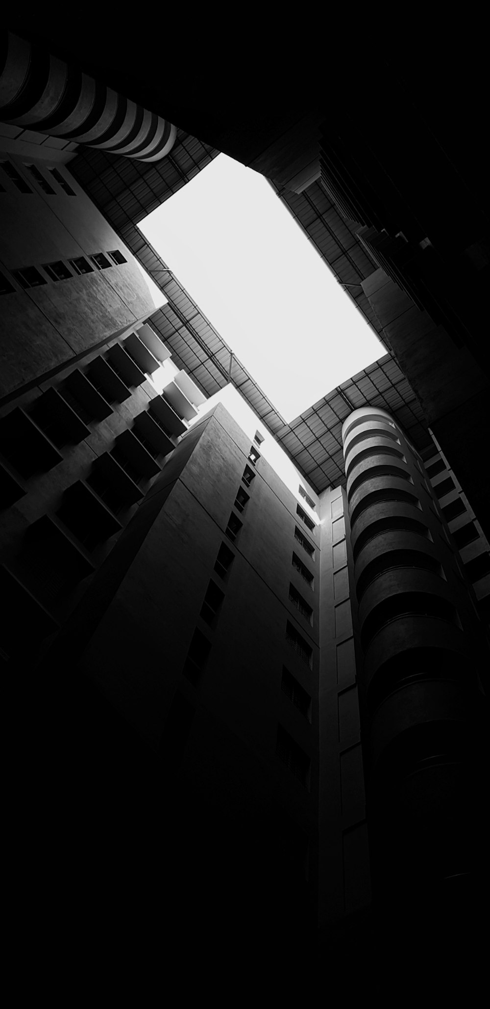 low-angle grayscale photography of a high-rise building