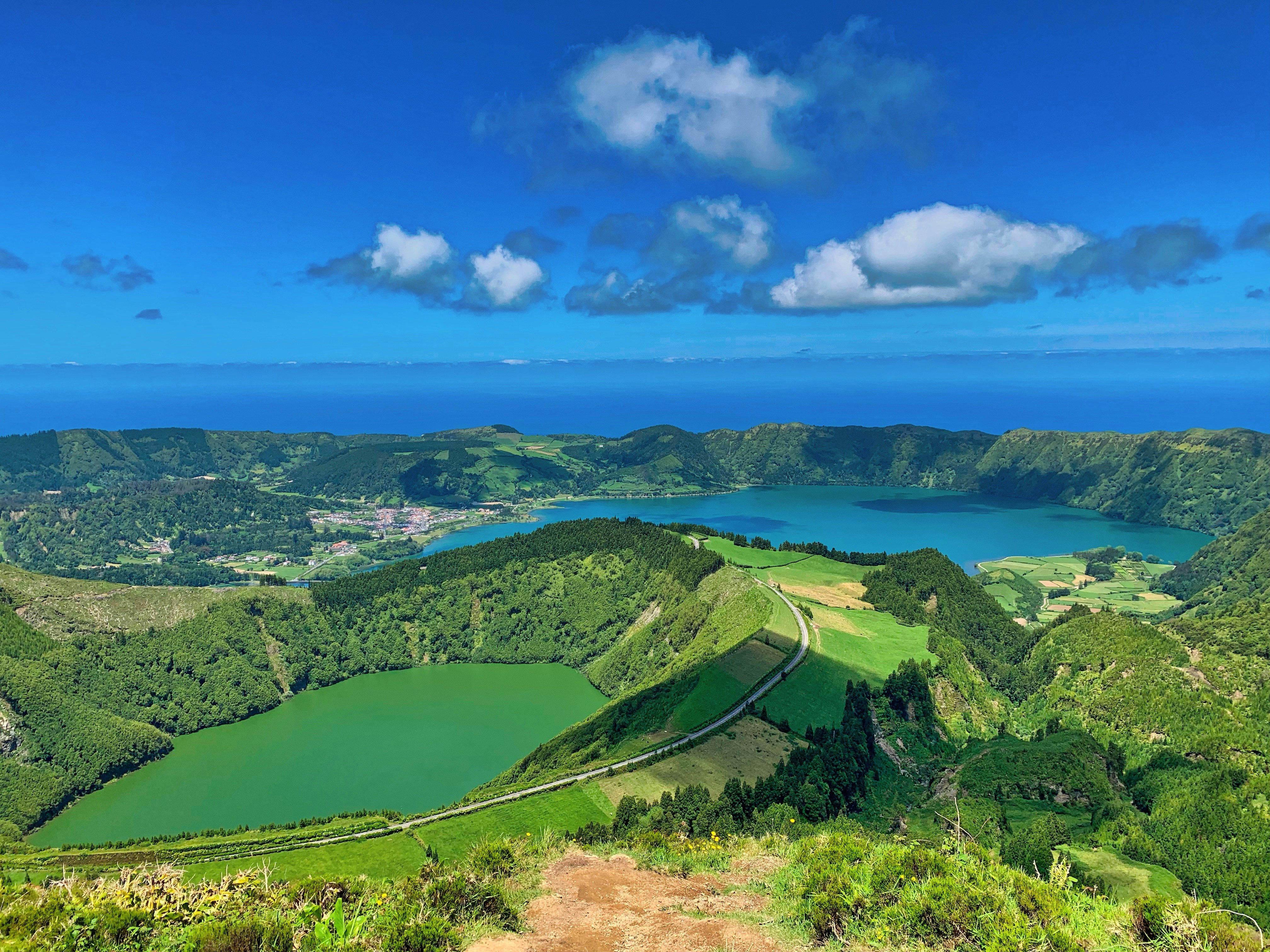 aerial photography of green mountains under a blue sky