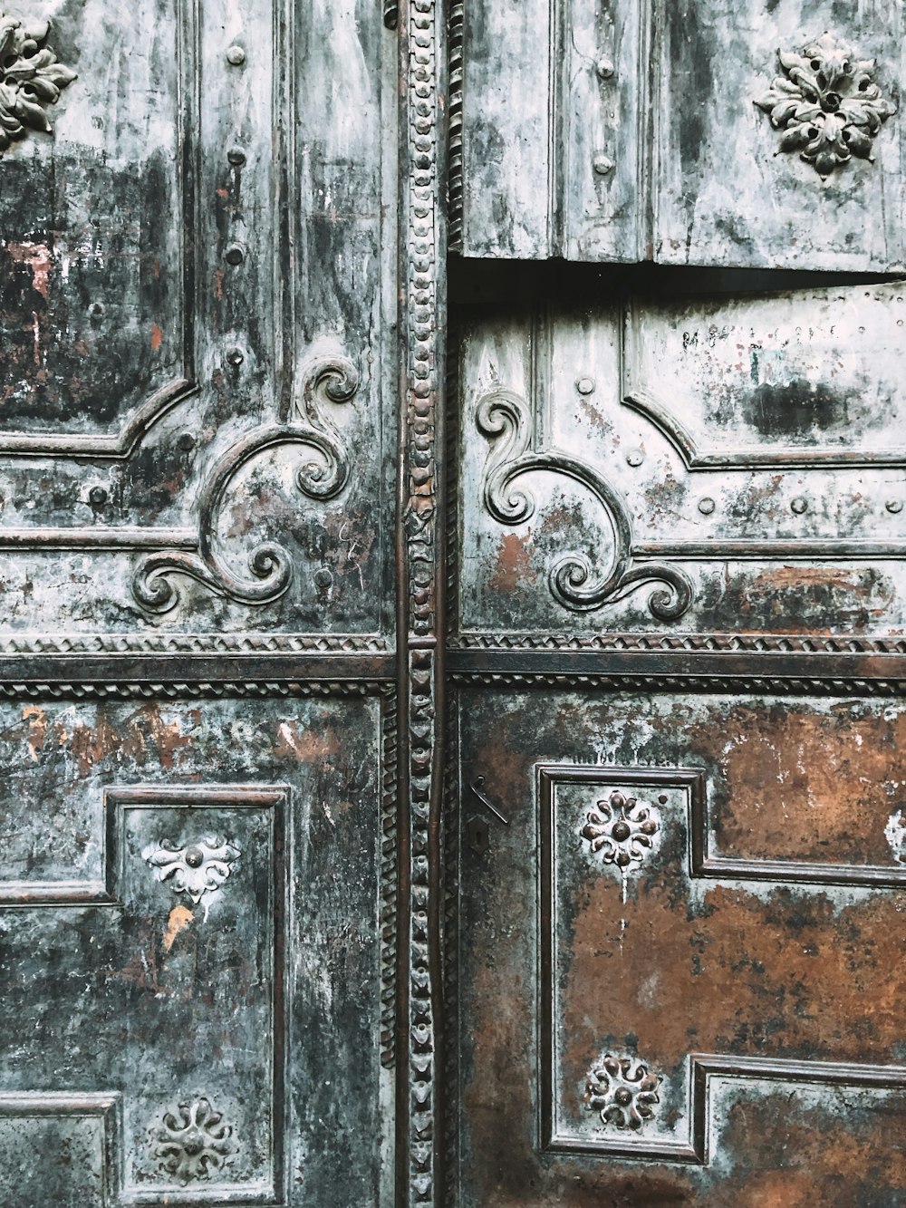 a close up of a metal door with ornate designs