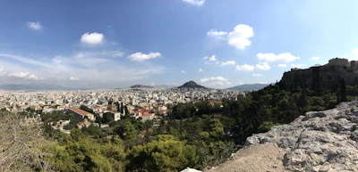 A panoramic view of Abuja's modern cityscape with the Aso Rock towering in the background.