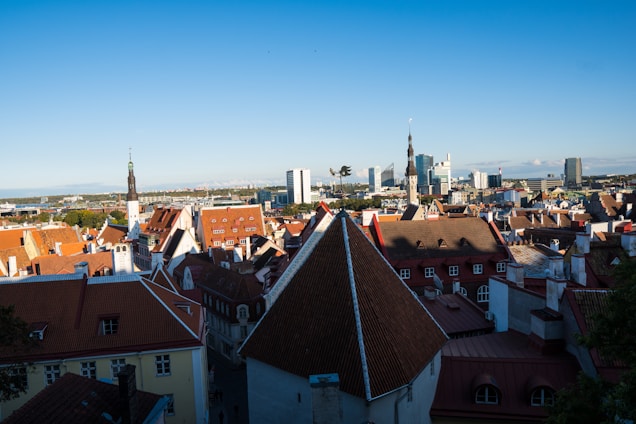 A panoramic view of Riyadh city skyline blending modern skyscrapers with traditional architecture under a clear blue sky.