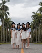 four women wearing white dress
