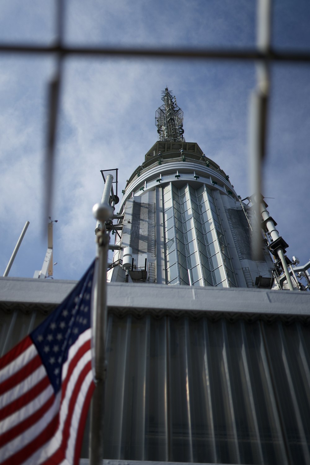 low-angle photography of gray building by USA flag
