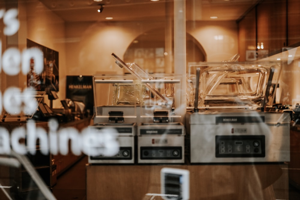 a store window with a reflection of a machine in it