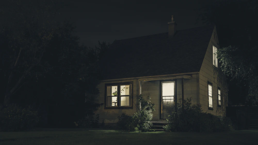 House at dusk with the lights on inside