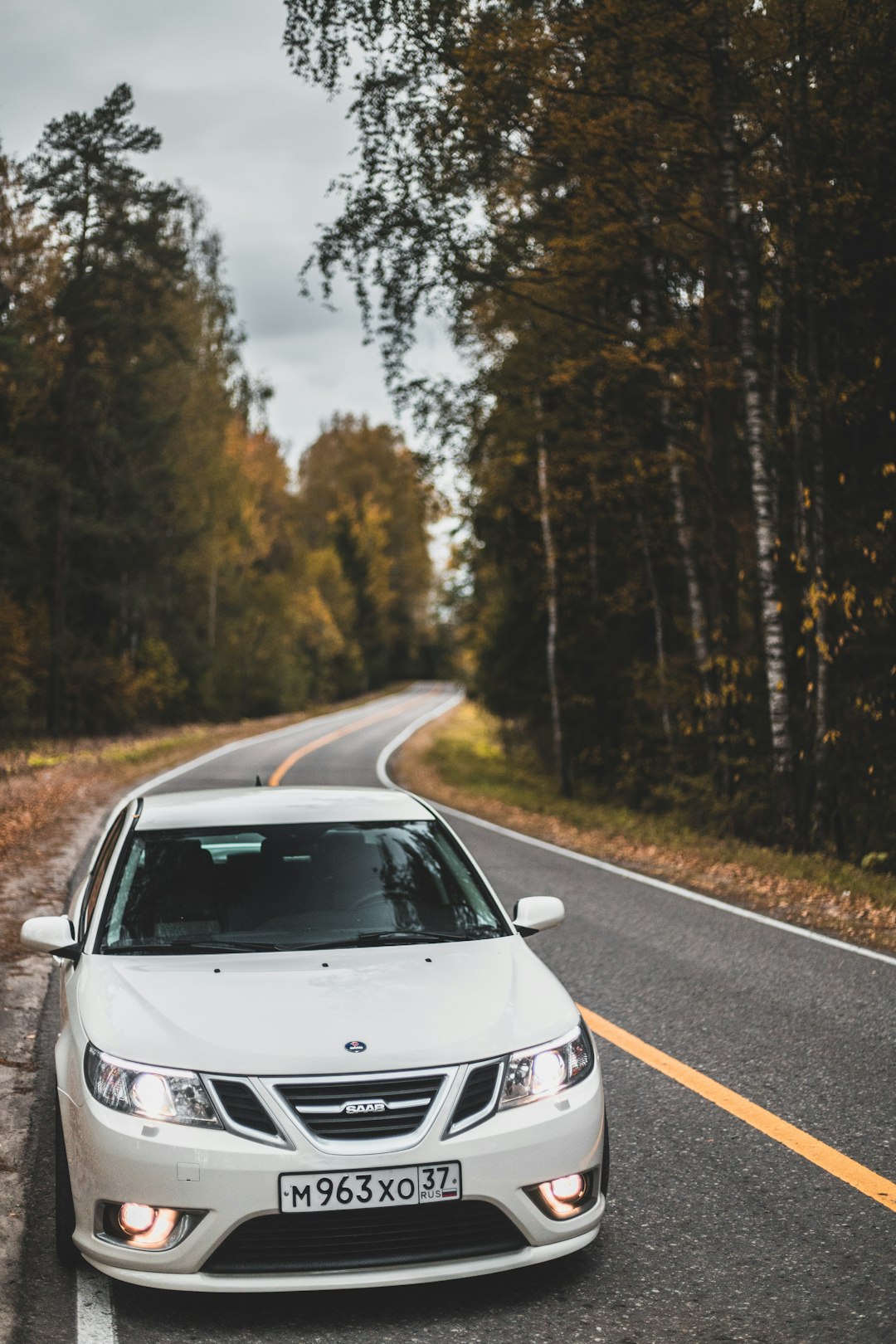 white vehicle on road at daytime