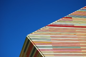 Exterior of a building showing a freshly painted colorful facade under clear sky.