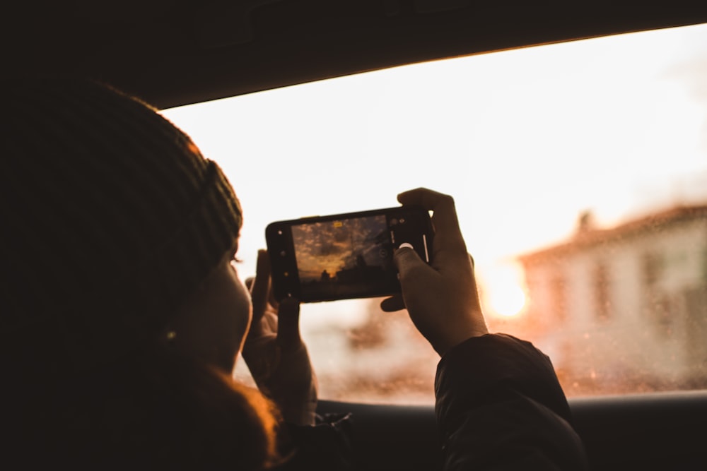 woman holding Android smartphone