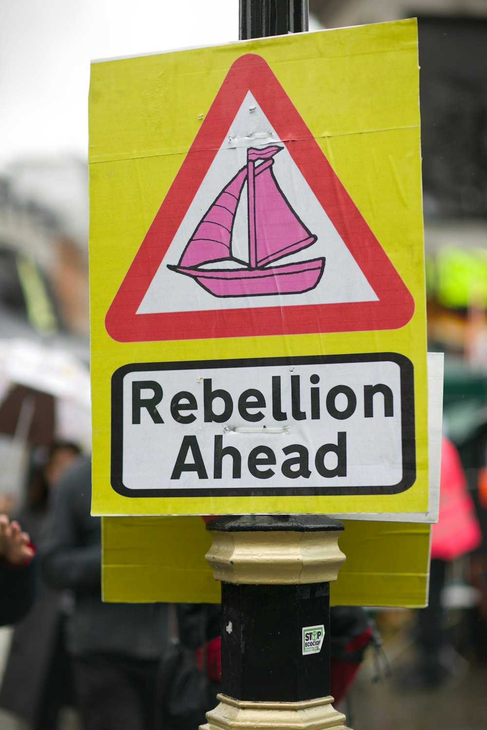 yellow and red rebellion ahead board signage