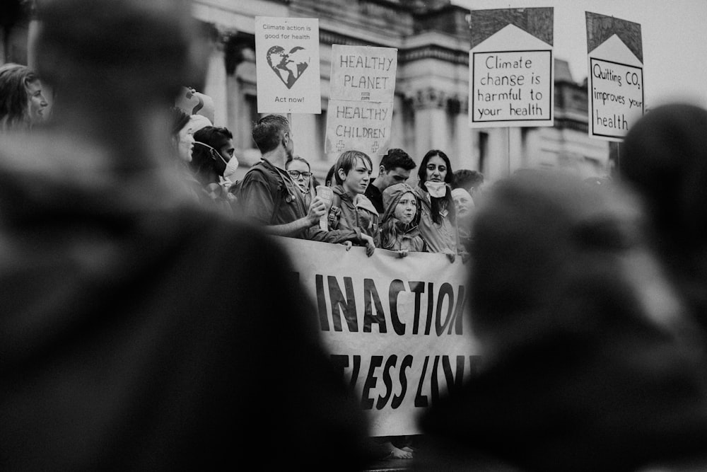 grayscale photography of people on a rally