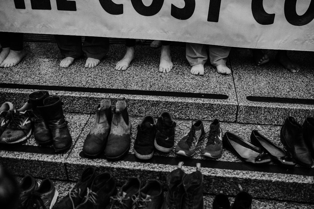 grayscale photography of shoes on stiars