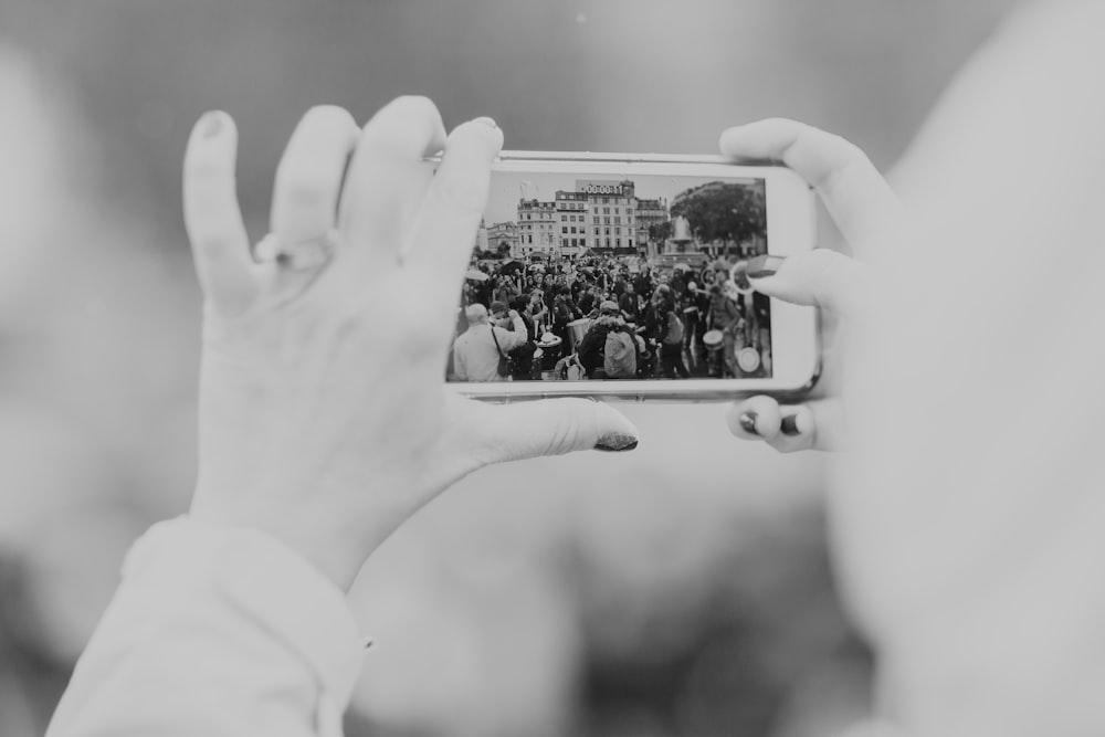 greyscale photography of person taking photo