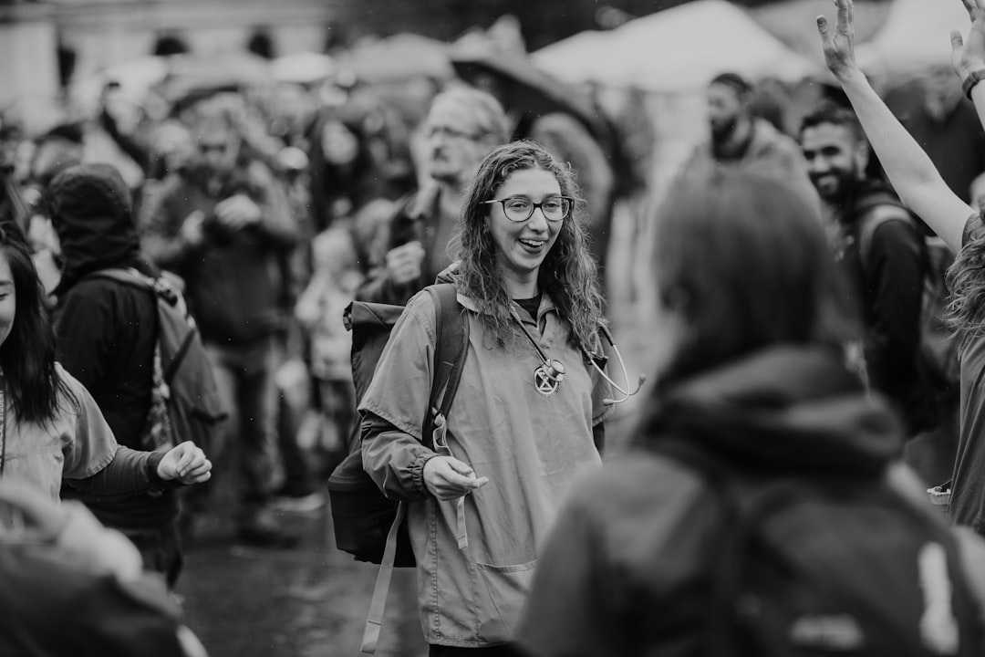 grayscale and selective focus photography of smiling woman