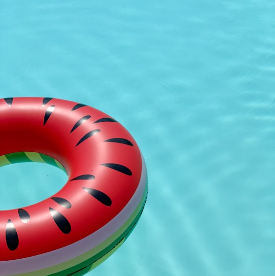 red and green lifebuoy on swimming pool