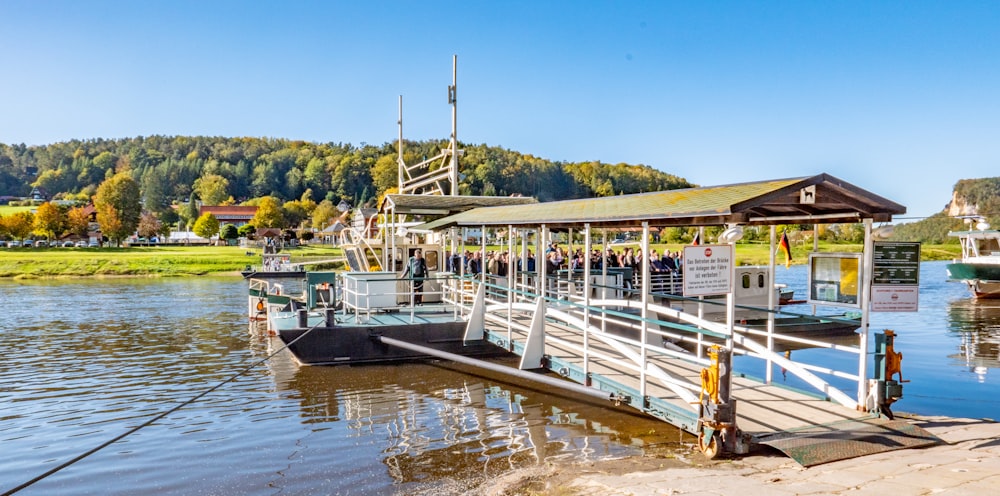 white and brown dock beside body of water at daytime