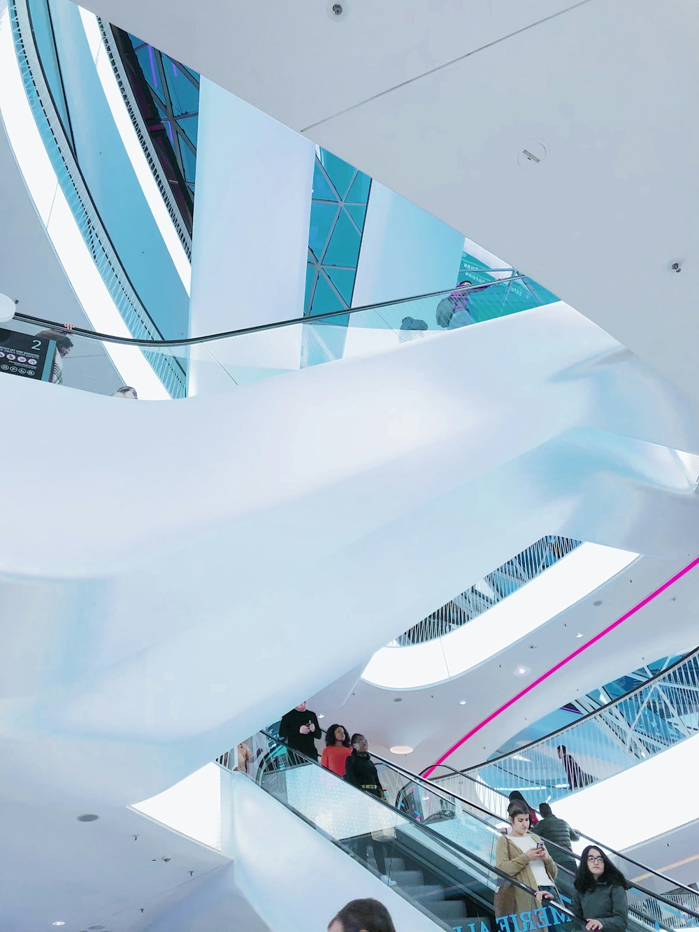 people on escalator inside building