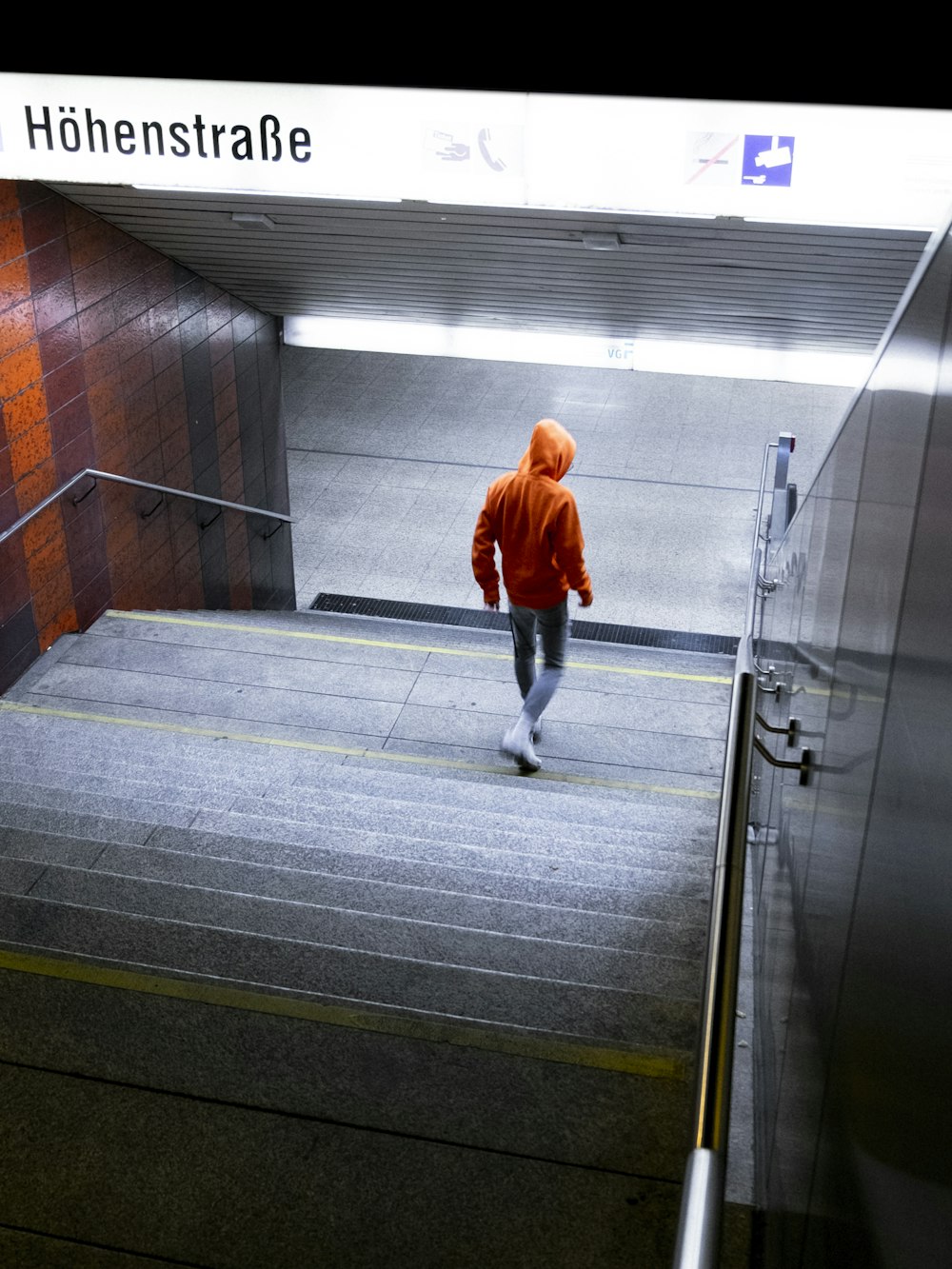 man wearing orange hooded jacket screengrab