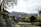 Guests hiking along a tree-lined path on Luxury Hill with panoramic views of the city below.