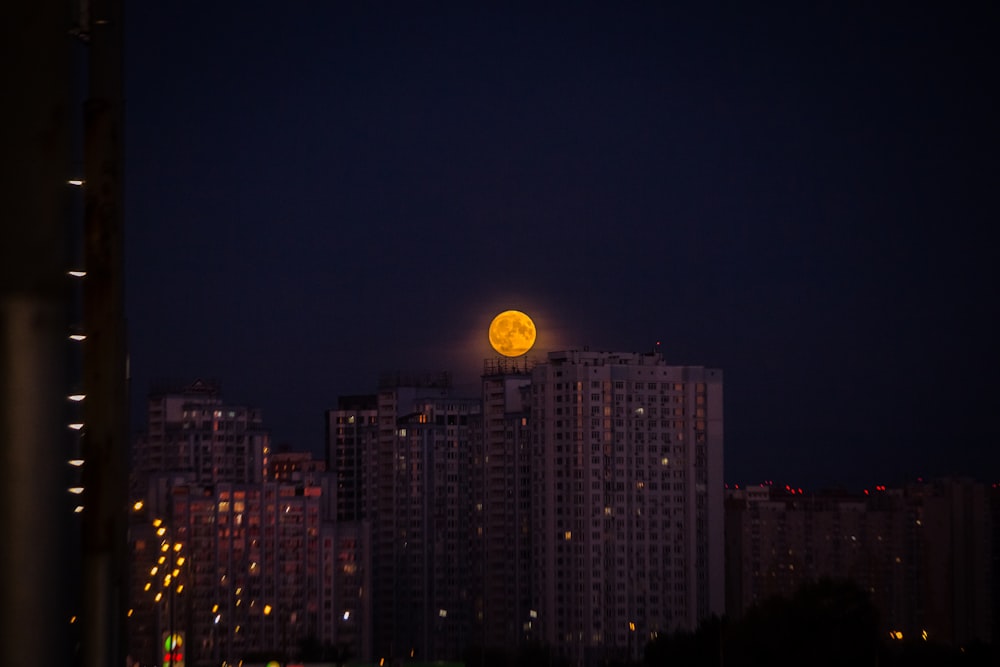 round full moon over buildings