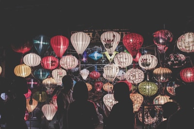 A vibrant photo of a community gathering during Ramadan, with lanterns glowing warmly.