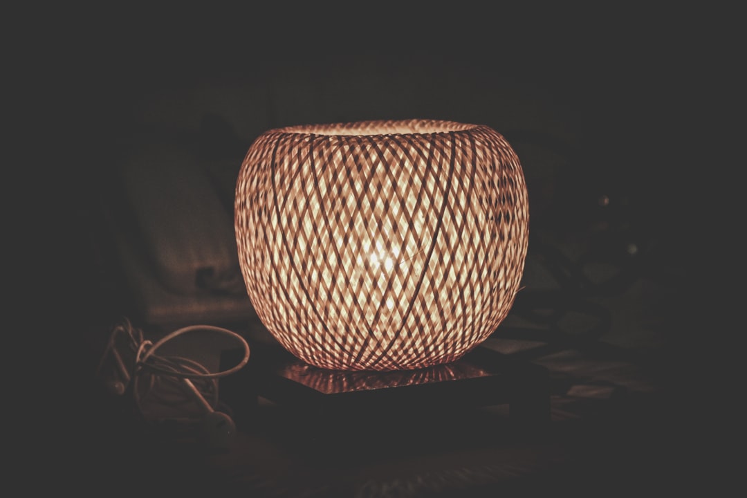 brown mesh table lamp turned on