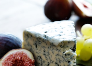 fruits and cheese on wooden surface