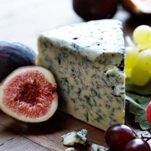 fruits and cheese on wooden surface