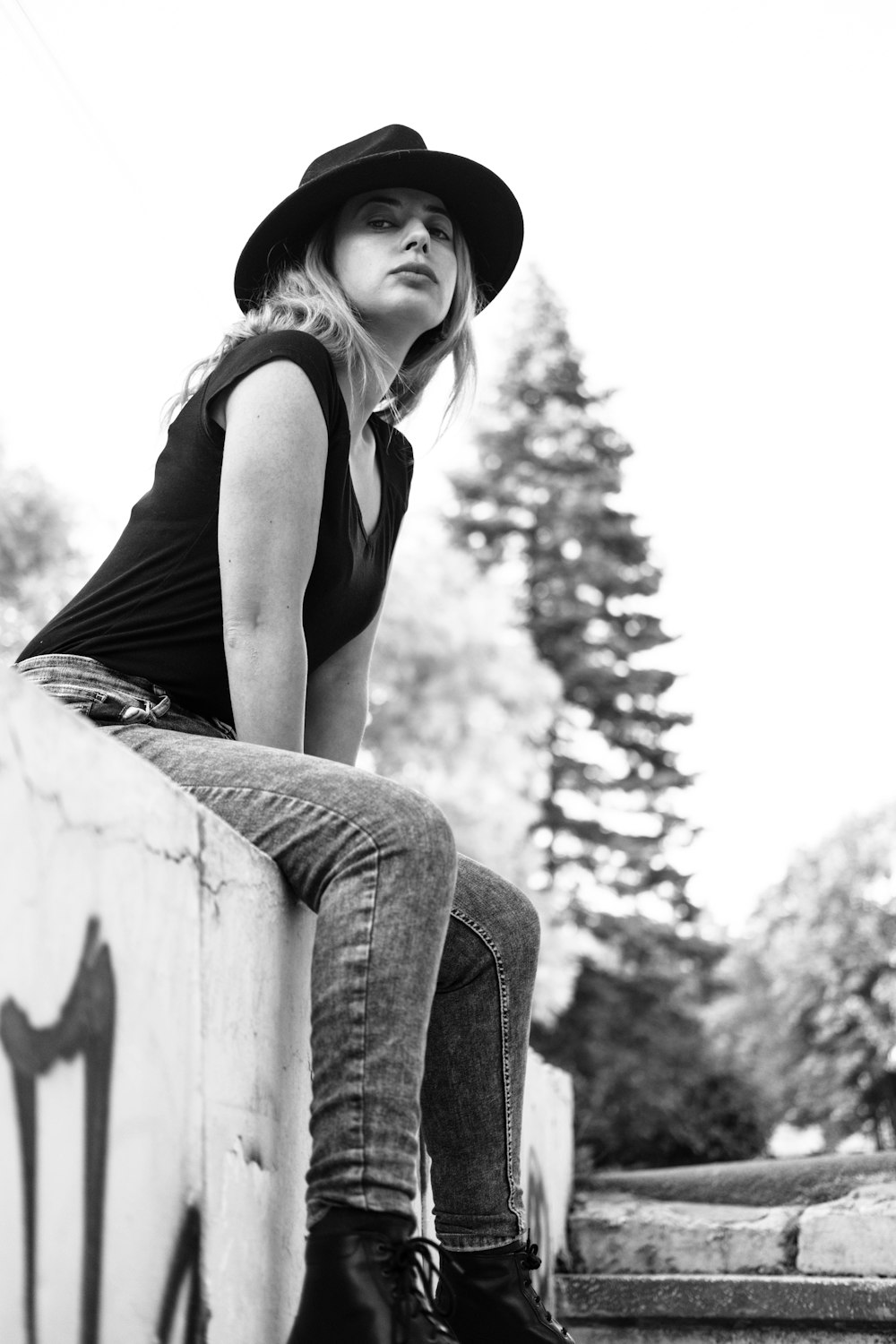 sitting woman wearing hat and shirt