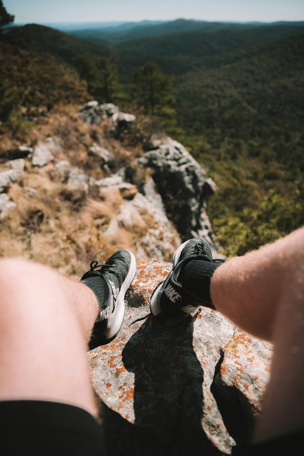 person sits on mountain